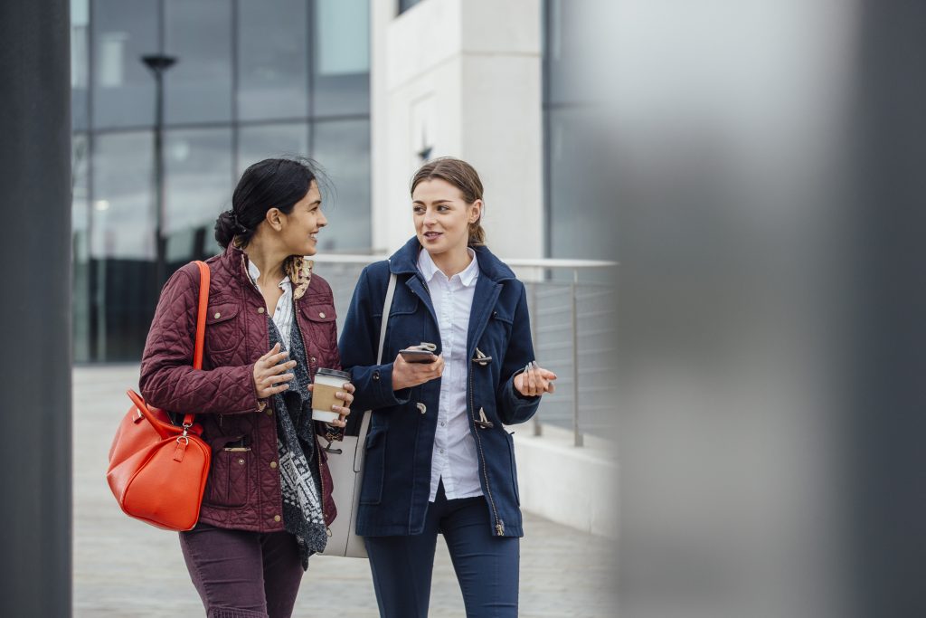 Businesswomen,Are,Walking,To,Work,Together,Through The City